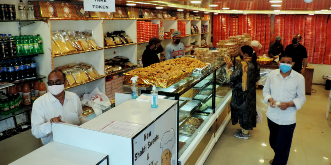 People purchasing Sweets and bakery items as authorities allowed selected shops to function in view of  Eid-Ul-Fitr amid strict lockdown in place in Kashmir valley