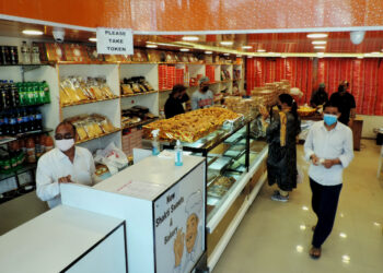 People purchasing Sweets and bakery items as authorities allowed selected shops to function in view of  Eid-Ul-Fitr amid strict lockdown in place in Kashmir valley