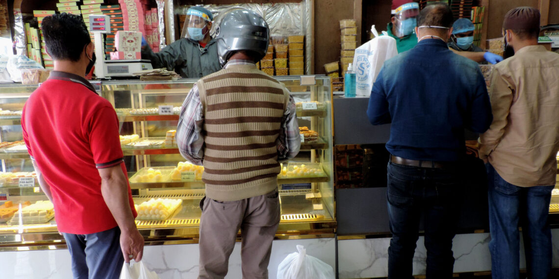 People purchasing Sweets and bakery items as authorities allowed selected shops to function in view of  Eid-Ul-Fitr amid strict lockdown in place in Kashmir valley