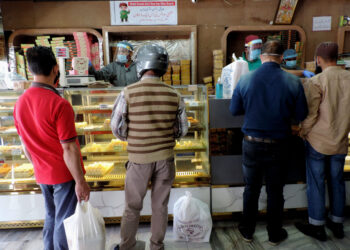 People purchasing Sweets and bakery items as authorities allowed selected shops to function in view of  Eid-Ul-Fitr amid strict lockdown in place in Kashmir valley
