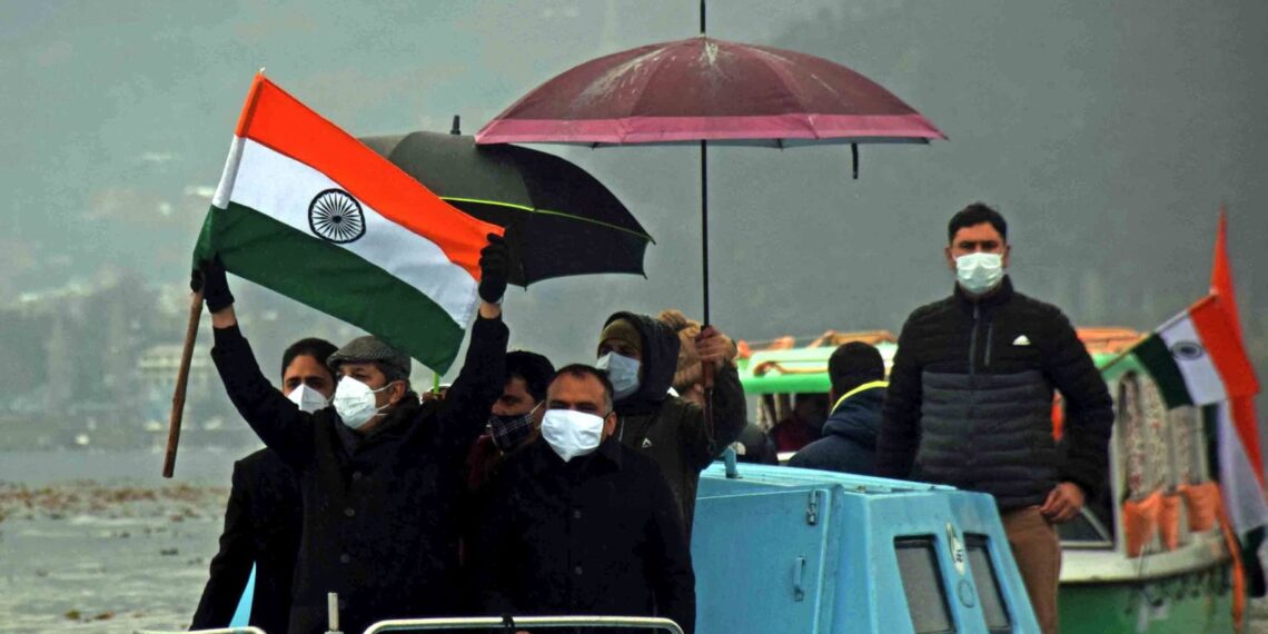 Advisor Baseer Khan flanked by Div Com Kashmir and SMC Mayor waving tricolor to flag off the Shikara Rally in  Dal Lake in Srinagar