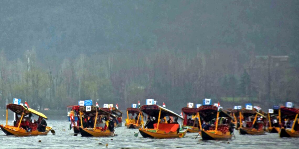 Advisor Baseer Khan flanked by Div Com Kashmir and SMC Mayor waving tricolor to flag off the Shikara Rally in Dal Lake in Srinagar