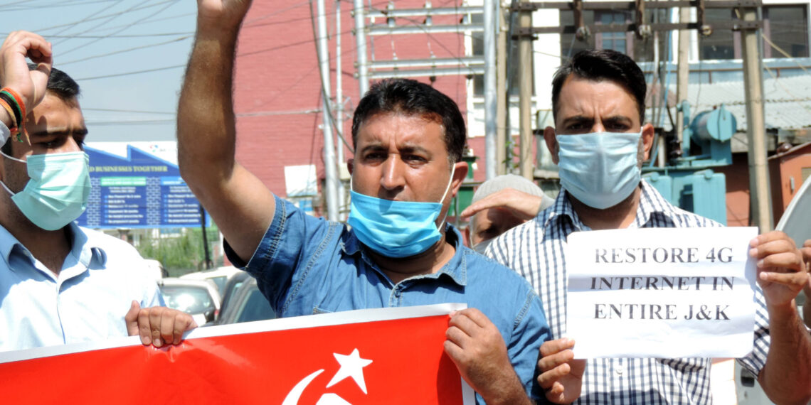 CPI(M) activists with banners and placards protesting at Press Enclave at Residency road in Srinagar