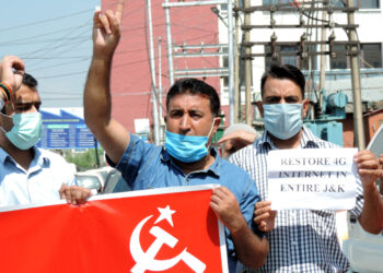 CPI(M) activists with banners and placards protesting at Press Enclave at Residency road in Srinagar