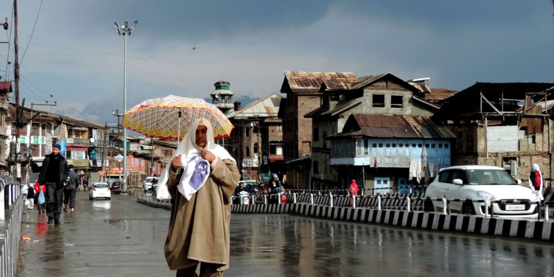 Woman holding an umbrella on a rainy day in Srinagar