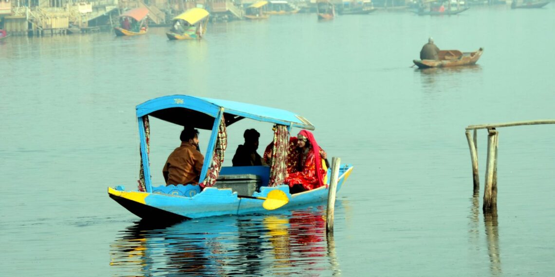 Tourists enjoying shikara ride on a cool day at world famous Dal lake in Srinagar