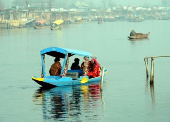 Tourists enjoying shikara ride on a cool day at world famous Dal lake in Srinagar