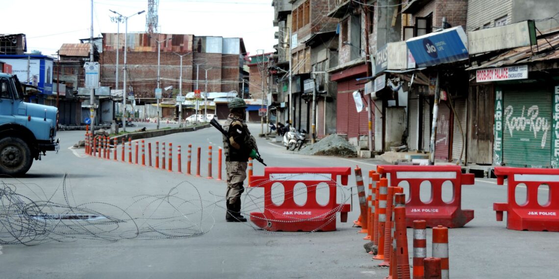 COVID-19: A security personnel keeping guard on road in Srinagar