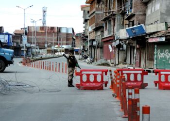 COVID-19: A security personnel keeping guard on road in Srinagar