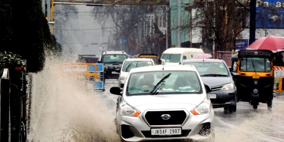 Students walking down the Lal Chowk in Srinagar amid rain fall in Srinagar