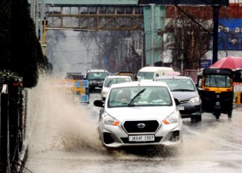 Students walking down the Lal Chowk in Srinagar amid rain fall in Srinagar