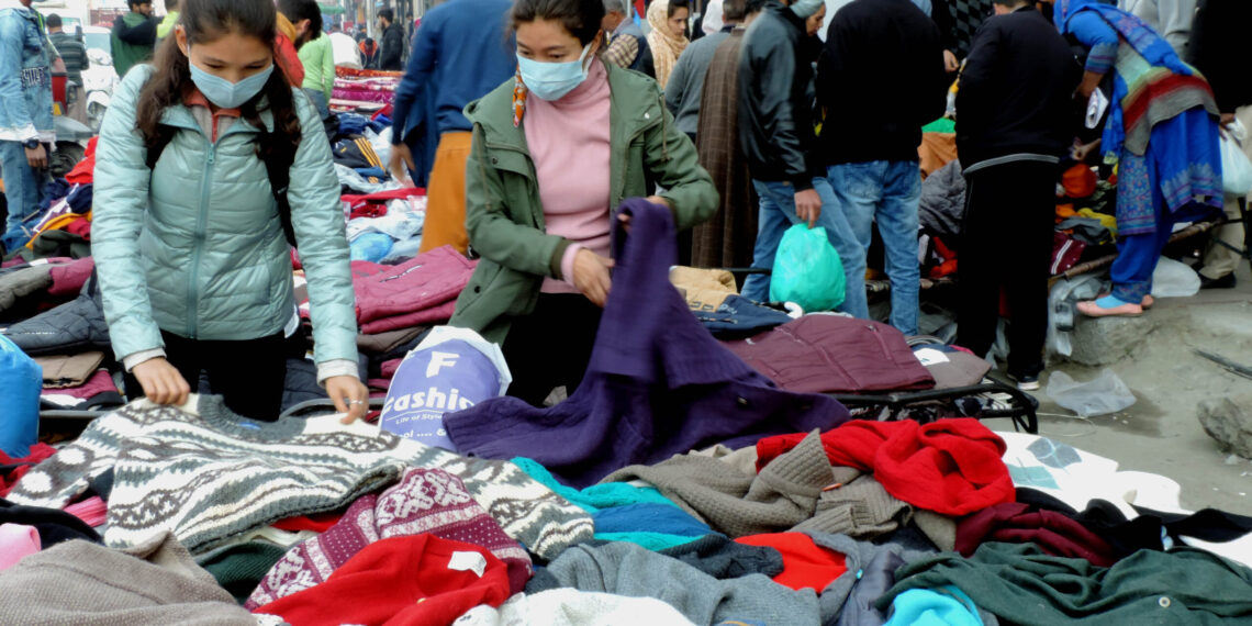 People purchasing winter clothes at Sunday market in Srinagar