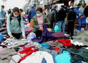 People purchasing winter clothes at Sunday market in Srinagar