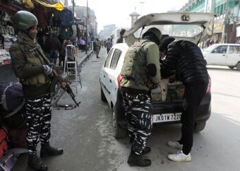 CRPF troopers checking and frisking people at Lal chowk ahead of Republic day  in Srinagar on Thursday-Pic/ Kashmir Horizon