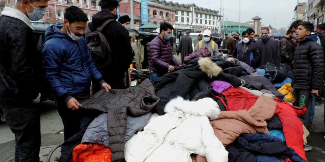 People purchasing winter clothes at Sunday market in Srinagar