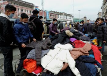 People purchasing winter clothes at Sunday market in Srinagar