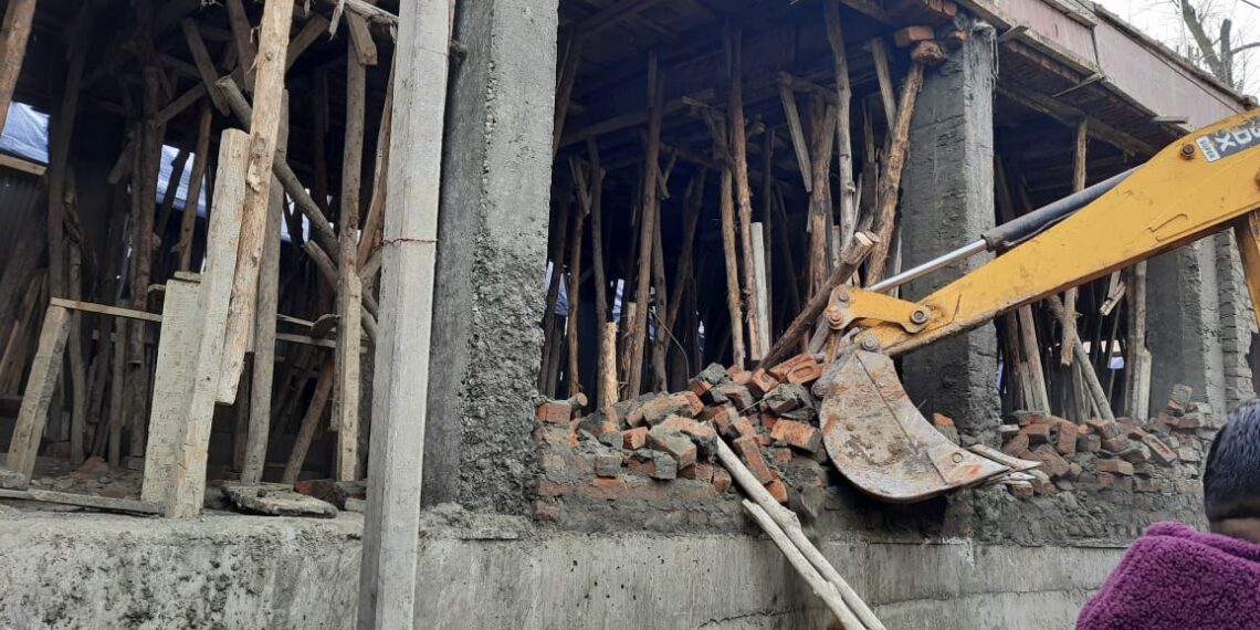 SMC demolishes shops at Aaliyaba HMT in Srinagar outskirts