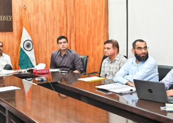 Div Com Jammu reviews progress of National Clean Air Program Committee approves ITLS at identified locations of Jammu KH News Service Jammu | Sept. 15:Divisional Commissioner Jammu, Ramesh Kumar, Tuesday chaired a meeting to review the progress in implementation of the approved Action Plan for improvement of air quality in Jammu District under the National Clean Air Programme (NCAP). The Divisional Commissioner is also the Chairperson of the District Level Monitoring Committee for monitoring the approved action Plan under NCAP. Commissioner Jammu Municipal Corporation, Devansh Yadav, Member Secretary of the Committee; Deputy Commissioner Jammu, Rakesh Minhas- the Member; Joint Commissioner JMC Abdul Sattar – the Nodal Officer; a representative from the J&K Pollution Control Committee, besides other concerned officers were present in the meeting. The Member Secretary briefed the Committee about the NCAP Action Plan 2026-27, including the financial allocation, expenditure, completed and ongoing works and proposed interventions aimed at improving air quality in Jammu city. He also listed other physical and financial achievements. The Committee reviewed various measures under the Action Plan, including road and footpath improvement, development of green spaces and vertical gardens, park improvement, pothole repair, traffic management, solid waste and construction & demolition waste management, besides the awareness activities. After detailed deliberations, the Committee approved the Integrated Traffic Light System (ITLS) at identified locations in Jammu to strengthen traffic management through an integrated and coordinated system. The Committee also approved the supplementary plan and plantation proposal for KotBhalwal and Bhagwati Nagar, aimed at strengthening green cover and improving the urban environment. The Committee further decided to re-examine the projects proposed to be taken up under the NCAP Action Plan 2026-27, with a focus on prioritising interventions having greater impact on air quality and ensuring effective utilisation of available resources. The Divisional Commissioner directed the concerned officers to ensure timely completion of ongoing works and put in place a sustainable mechanism for proper maintenance of assets created under NCAP. He stressed that new green spaces, parks and other interventions be developed at suitable locations where their regular upkeep can be ensured. He further directed the officers to expedite implementation of the approved measures, with emphasis on dust control, road improvement, traffic management, greenery and effective solid waste management for achieving the objectives of the National Clean Air Programme.