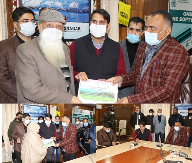 Div Com (K), DC Srinagar hand over Land Passbooks to land owners