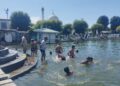 Amid sweltering hot weather conditions children taking bath in the waters of iconic Dal Lake at Hazratbal in Srinagar