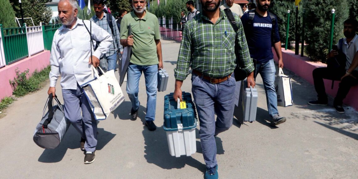 Polling officials leave after collecting EVM & other election material ahead of 2nd phase assembly elections in Srinagar
