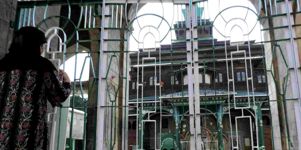 COVID-19: A devotee paying obeisance at the closed gate of shrine of Ameer-e-Kabeer Mir Syed Ali Hamdani at Khan-e-Kah-e-Molla in down town Srinagar on Friday