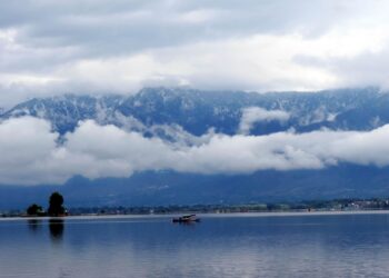 In Pictures- Rains lashes plains, upper reaches experiences snowfall in Kashmir
