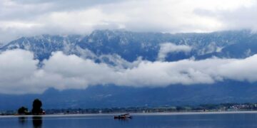 In Pictures- Rains lashes plains, upper reaches experiences snowfall in Kashmir